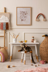 Cozy composition of kids room interior with mock up poster frame, white desk, animal wicker basket,...