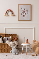 Cozy composition of kids room interior with mock up poster frame, wicker basket, plush animal toys,...