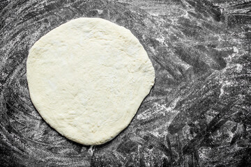 Rolled out pizza dough.