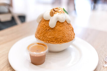 Thai Tea shaved ice with whipped cream and milk tea sauce.