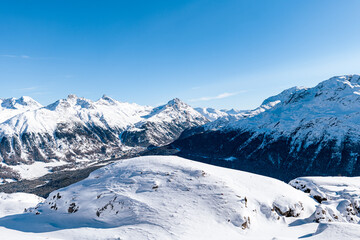 Fototapeta na wymiar View of winter snowy mountain landscape on a sunny day around St. Moritz, Switzerland.