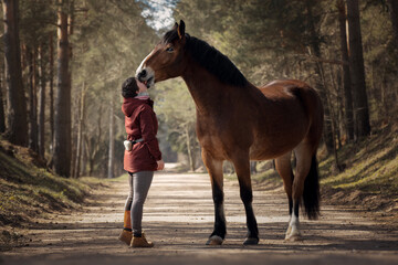 Girl with her beautiful bay horse