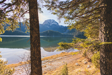 Beautiful view of Black lake, Crno Jezero in Durmitor National Park, Zabljak, northern Montenegro, landscape in a sunny day with blue sky, with glacial lake, forest hiking trail and mountain peaks