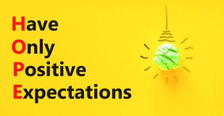 HOPE have only positive expectations symbol. Concept words HOPE have only positive expectations on yellow paper beautiful yellow background Business HOPE have positive expectations concept Copy space