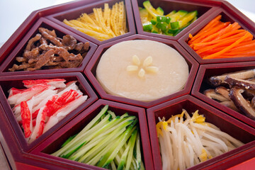 Gujeolpan; an elaborate Korean dish consisting of nine different foods assorted on a wooden plate...