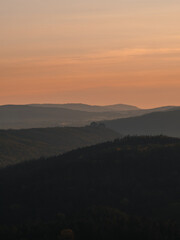 View of forest and hill landscape during sunset in the Czech Republic.