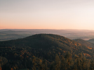 View of forest and hill landscape during sunset in the Czech Republic.