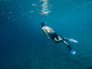 Fototapeta premium Young white caucasian man snorkeling underwater.