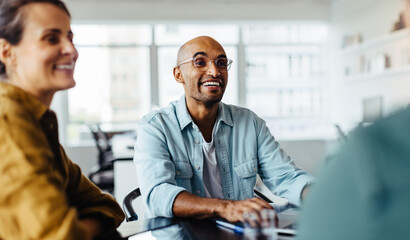 Business man sitting in a meeting with his team