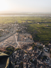 Aerial view of the Nile river and Luxor from a hot air balloon during sunrise.