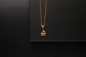 Fototapeta na wymiar Gold jewellery necklace on black background