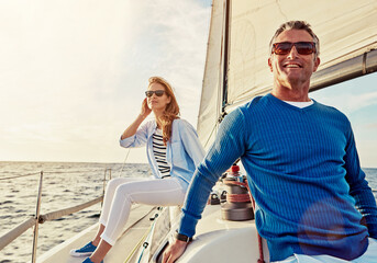 Mature couple, people or sailing yacht bonding on ocean, sea or water in relax holiday, vacation or summer adventure. Smile, happy man or woman on luxury boat in retirement travel location or freedom