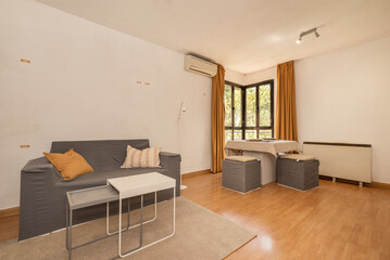 Dining room furnished with cardboard furniture and a dining table of the same material with gray upholstery and a coffee table on a carpet