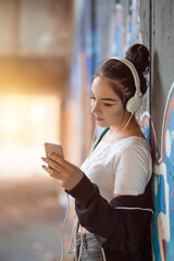 Girl at the skate park listening to music
