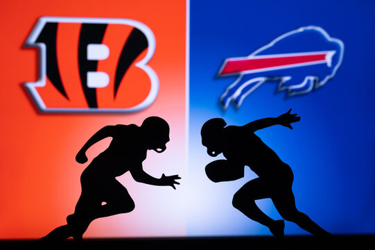 BUFFALO, USA, JANUARY 18, 2023: Cincinnati Bengals vs. Buffalo Bills. NFL Divisional Round 2023, Silhouette of two NFL American Football Players against each other. Big screen in background