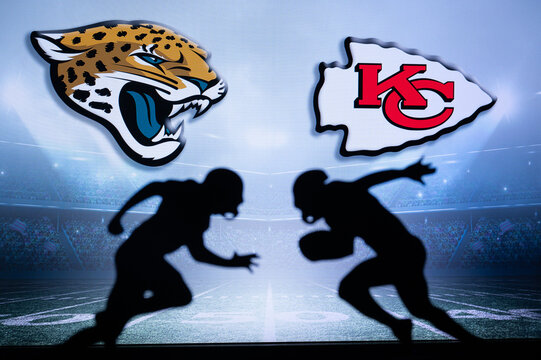 KANSAS, USA, JANUARY 18, 2023: Jacksonville Jaguars vs. Kansas City Chiefs. NFL Divisional Round 2023, Silhouette of two NFL American Football Players against each other. Big screen in background