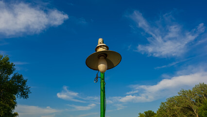 Old night lantern against the blue sky.