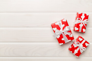 Gift boxes with hearts on wooden background, top view