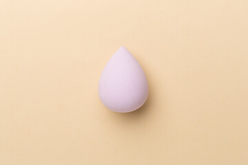 Beauty blender on color background, top view