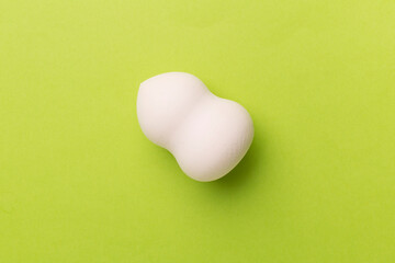 Obraz premium Beauty blender on color background, top view