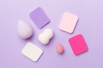 Beauty blenders on color background, top view
