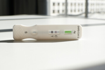 Positive self-diagnosis test for covid 19 or coronavirus or sars cov 2, is on a table in front of a...