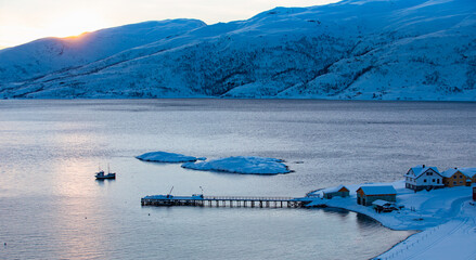 Norwegian traditional fishing small house on the bank of sea - Tromso, Norway