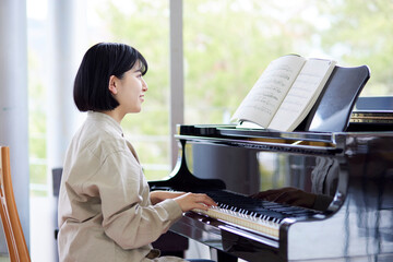 ピアノを演奏する若い日本人女性