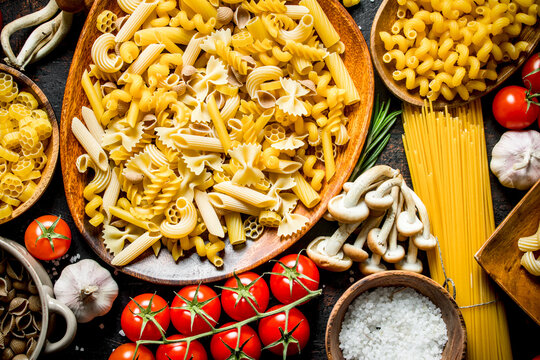 Different kinds of raw paste in bowls with garlic , mushrooms and cherry.