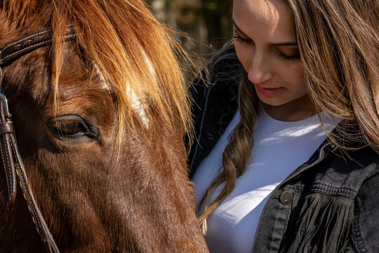 Lovely Brunette Cowgirl Enjoying A Day With Her Horse On Her Farm