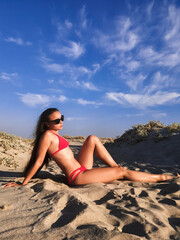 Portrait of beautiful woman in swimsuit standing on beach - 562412015