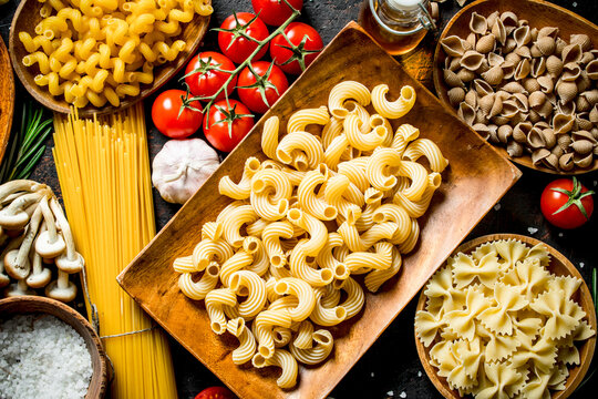 Different kinds of raw paste in bowls with garlic , mushrooms and cherry.