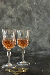 Close up two glasses of liquor, black background.