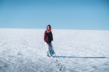 Girl in dress in snowy field