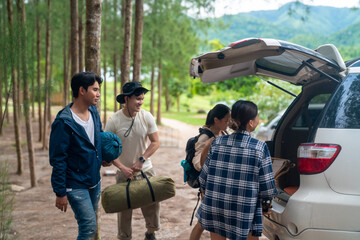 Group of Asian people friends enjoy outdoor lifestyle road trip and camping together on summer...