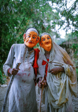Hindu religious village people celebrating gajan festival wearing colourful costumes 