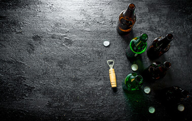 Open glass beer bottles and opener.