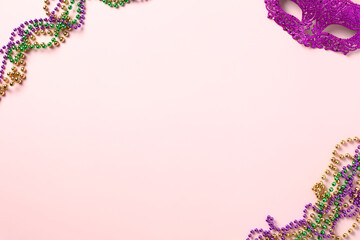 Mardi Gras Party invitation card design. Mardi Gras beads and carnival mask on purple background