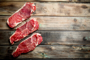 Raw beef steaks .