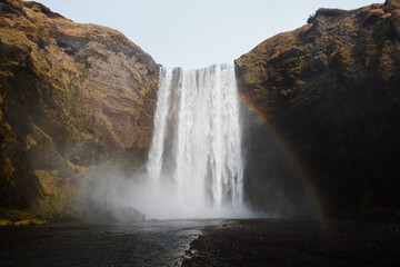 Rainbow near waterfall in nature