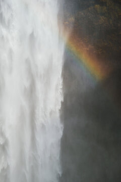 Rainbow near waterfall in nature