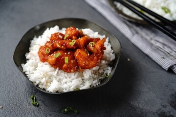Homemade sweet and sour chilli chicken served with jasmine rice, selective focus