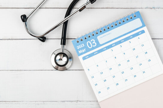 The May 2023 desk calendar and stethoscope medical on wooden background, schedule to check up healthy concepts.