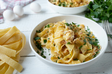 Pasta with scrambled eggs and parsley on a plate