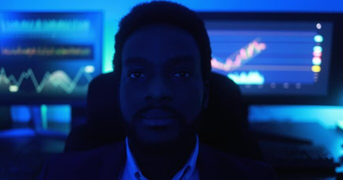 African trader working inside office ath night time - Trading, entrepreneur and technology concept