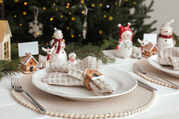Luxury place setting with beautiful festive decor for Christmas dinner on white table