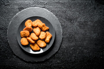 Chicken nuggets on the plate.