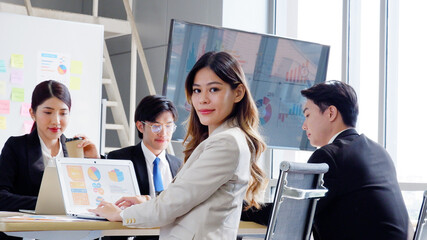 Young beautiful business woman sitting and smiling working at desk.