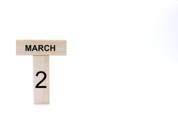 March 2 displayed wooden letter blocks on white background with space for print. Concept for calendar, reminder, date. 