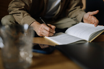 Man taking notes in home office close-up. Concept photo